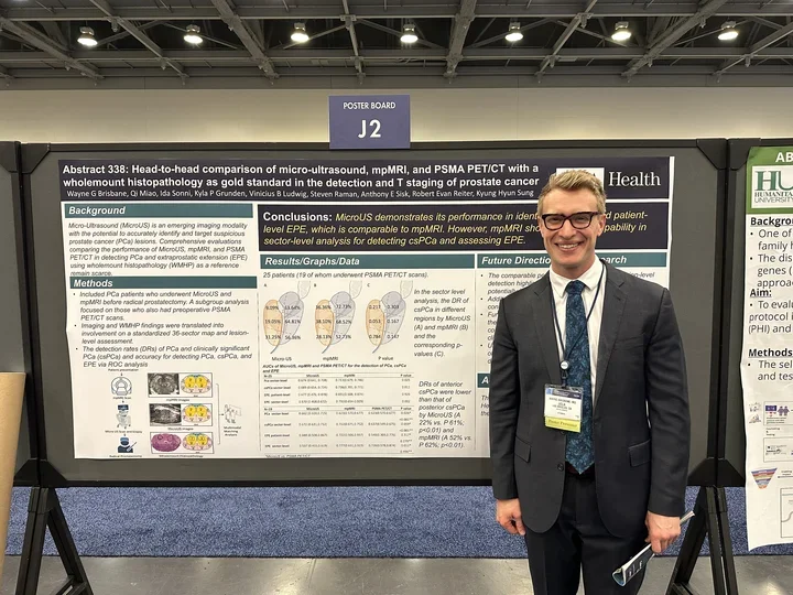 Wayne Brisbane standing in front of poster presentation