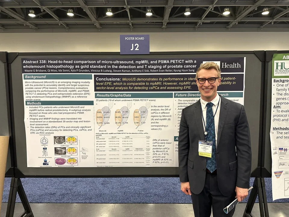 Wayne Brisbane standing in front of poster presentation